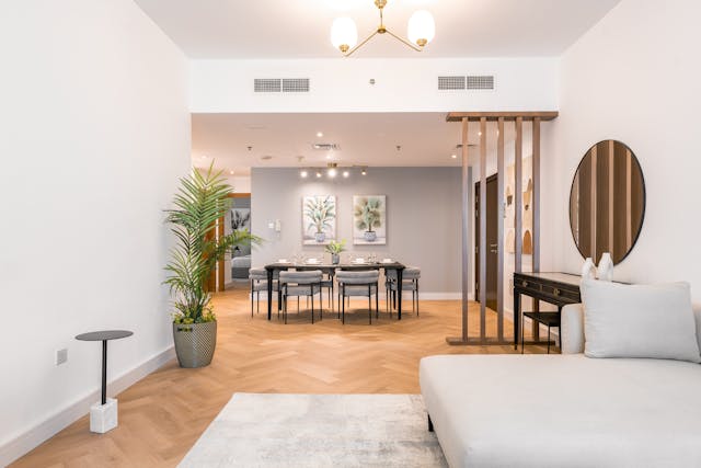 interior-of-a-living-room-featuring-a-couch-dining-table-and-wooden-floor
